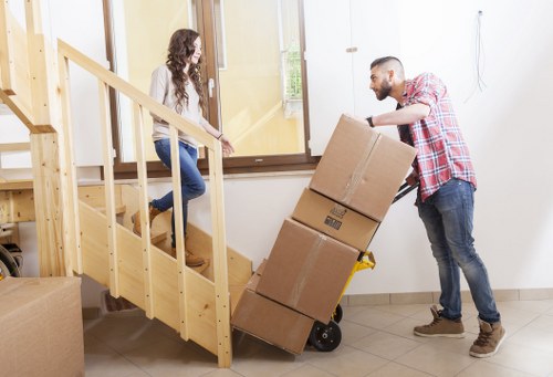 Packed moving boxes and furniture ready for removal in a central London flat